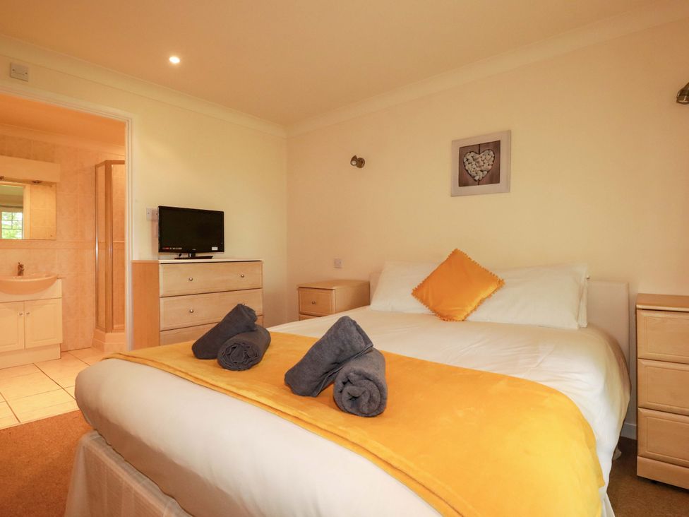A bedroom with a bed and tv at 4 bed number 20 in Newquay