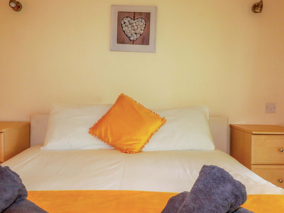 A bedroom with a bed and decorative elements at 4 bed number 20 Newquay