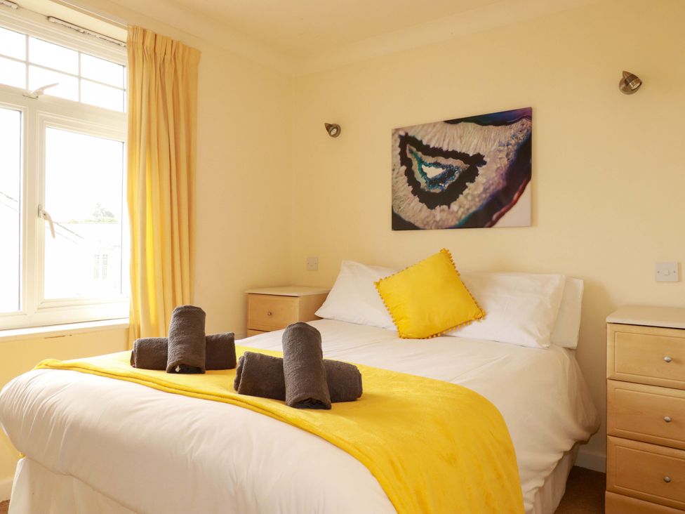 A bedroom with a bed and bedside table at 4 bed number 20 Newquay