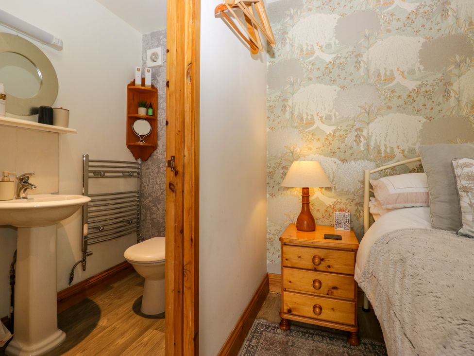 A bathroom with a sink and toilet with fixtures at La'al Yan in Branthwaite