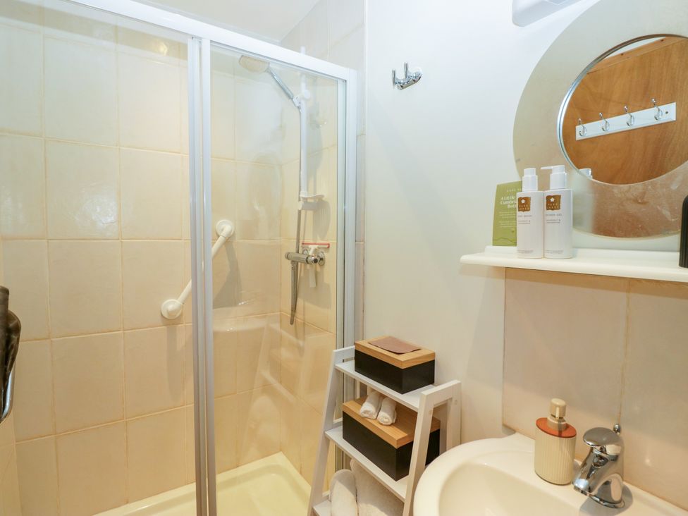 A bathroom with a shower and sink at La'al Yan, Branthwaite