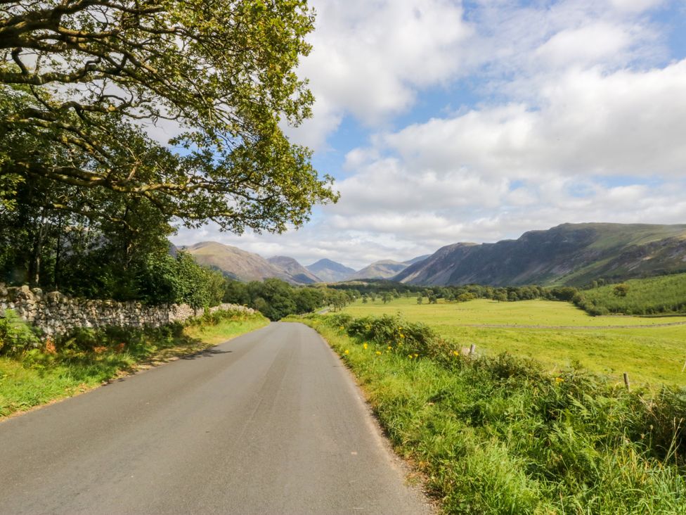 A scenic road with trees and fields at La'al Yan in Branthwaite