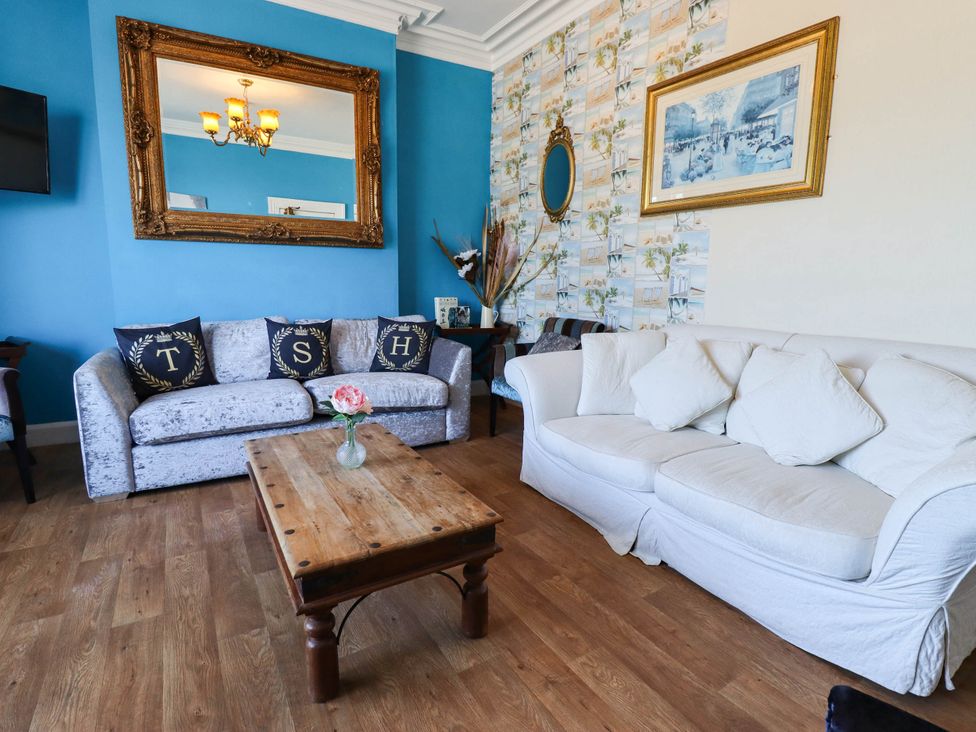 A living room with a sofa and coffee table at The Skegness Hotel in Skegness