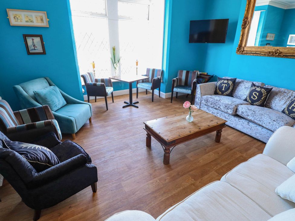 A living room with a coffee table and seating area at The Skegness Hotel in Skegness