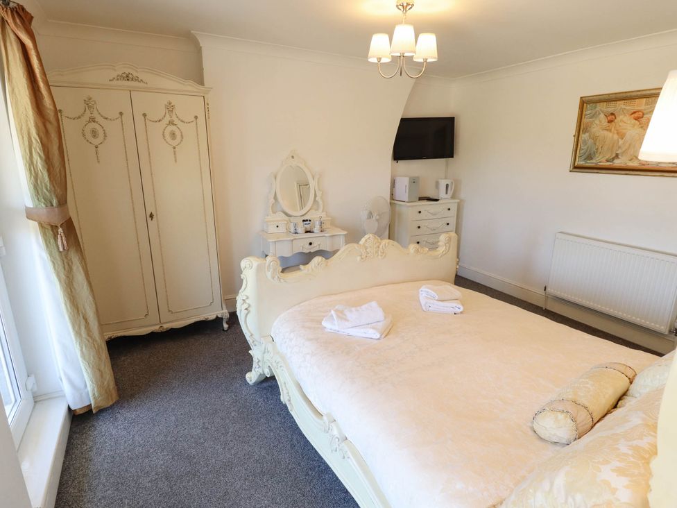 A bedroom with a bed and wardrobe at The Skegness Hotel in Skegness