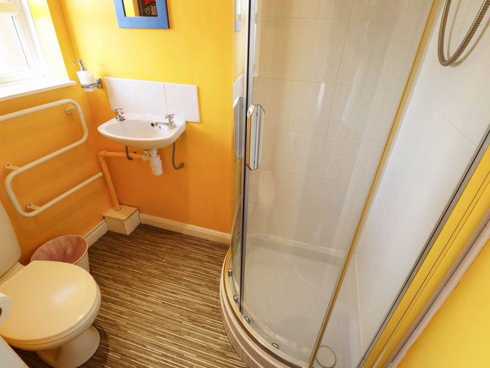 A bathroom with a toilet, sink, and shower at The Skegness Hotel in Skegness