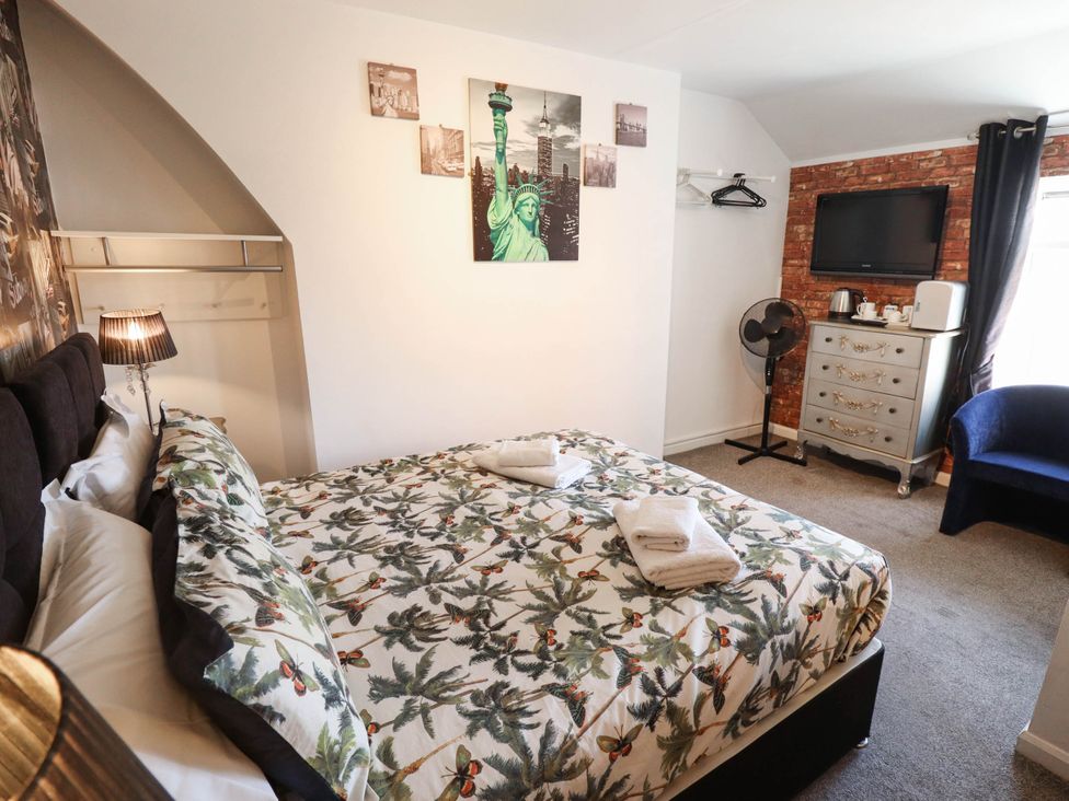 A bedroom with a bed and television at The Skegness Hotel in Skegness