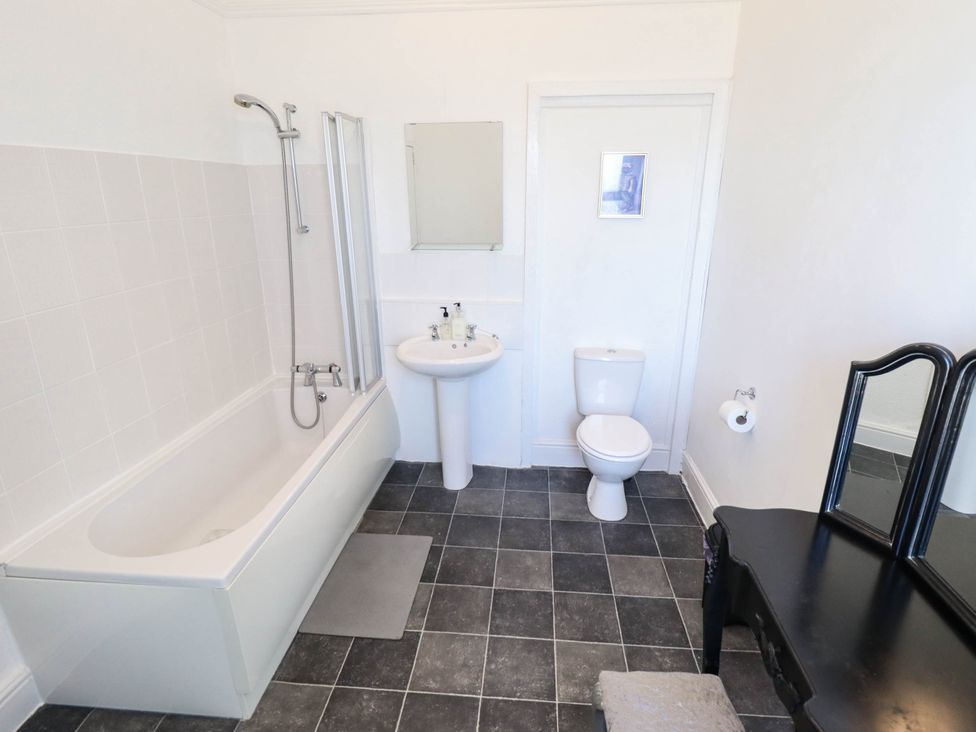 A bathroom with a bathtub, sink, and toilet at The Skegness Hotel in Skegness