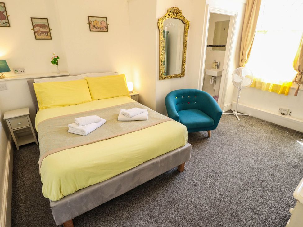 A bedroom with a bed and a chair at The Skegness Hotel in Skegness