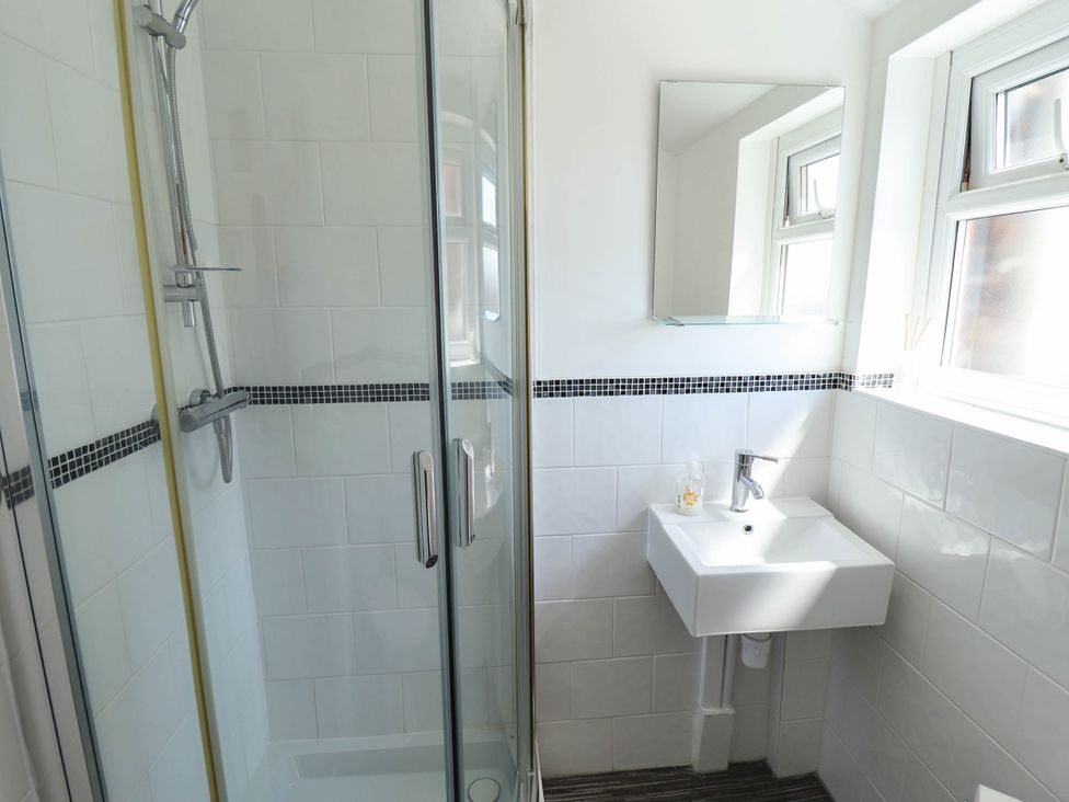 A bathroom featuring a shower, sink, and mirror at The Skegness Hotel in Skegness