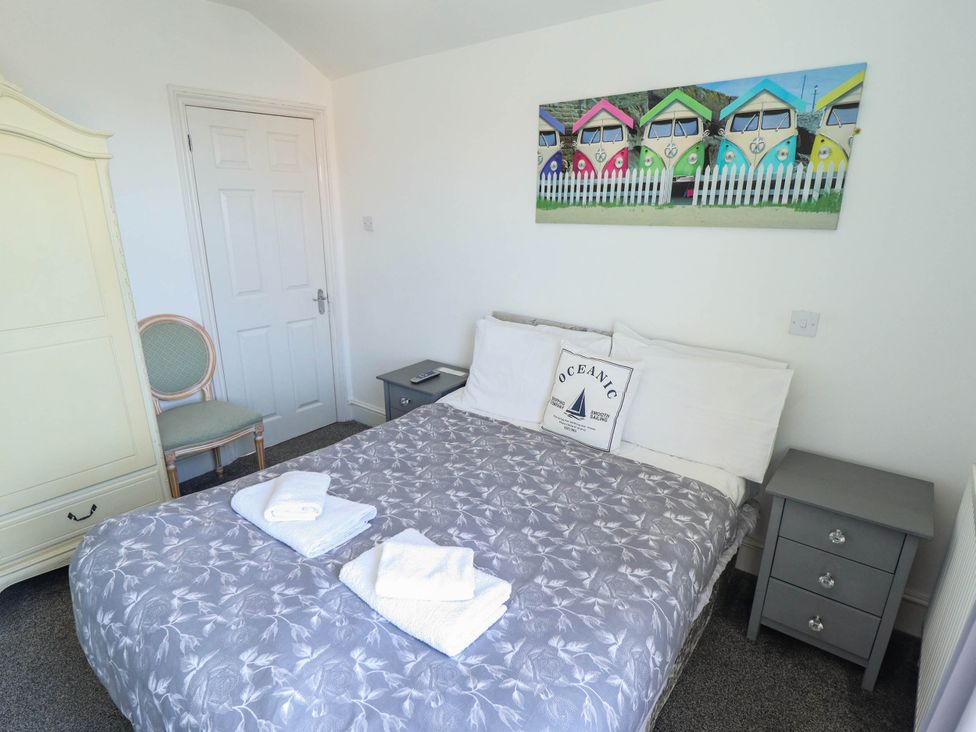 A bedroom with a bed and artwork at The Skegness Hotel in Skegness