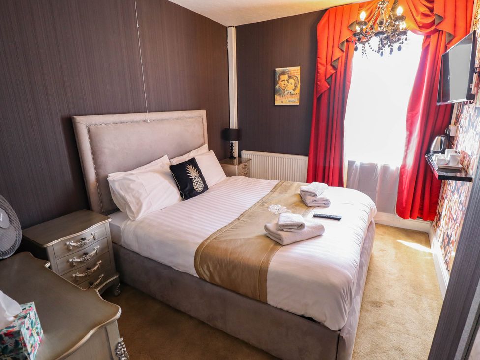 A bedroom with a bed and decorative items at The Skegness Hotel in Skegness