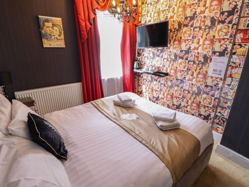 A bedroom with a bed and television at The Skegness Hotel in Skegness