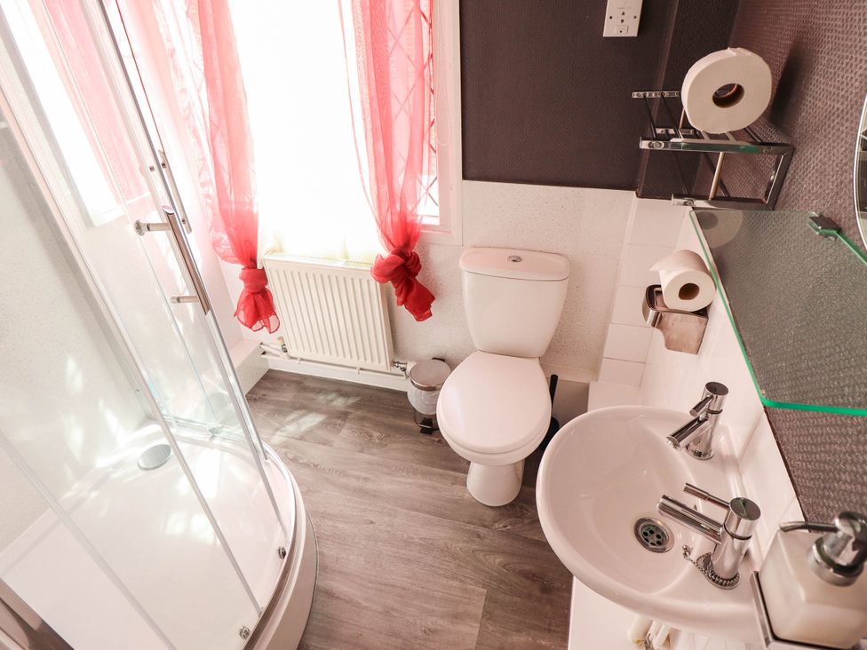 A bathroom with shower, toilet, and sink at The Skegness Hotel in Skegness