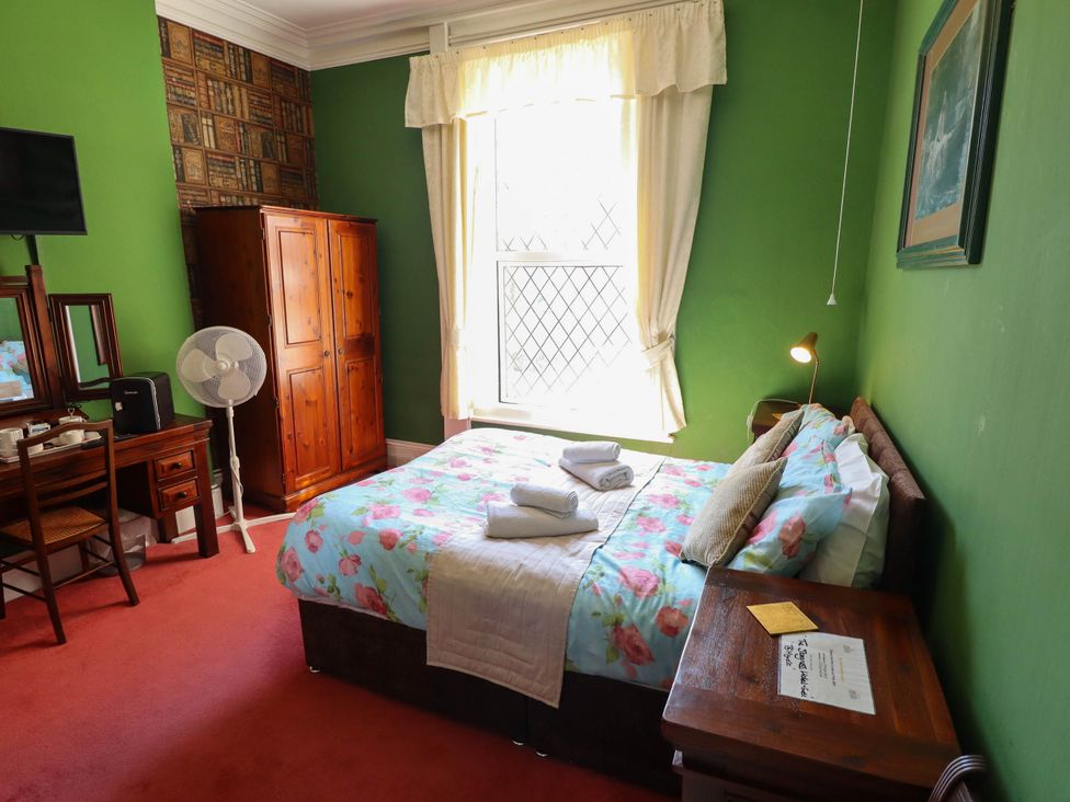 A bedroom with a bed and furniture at The Skegness Hotel in Skegness