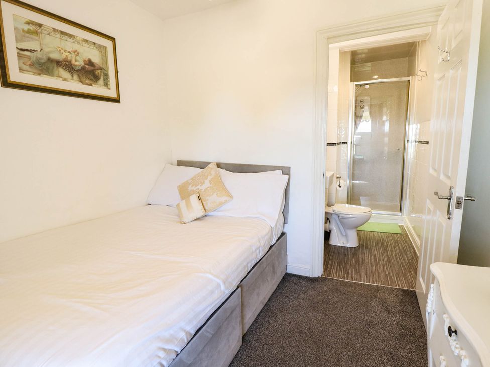 A bedroom with a bed and an attached bathroom at The Skegness Hotel in Skegness