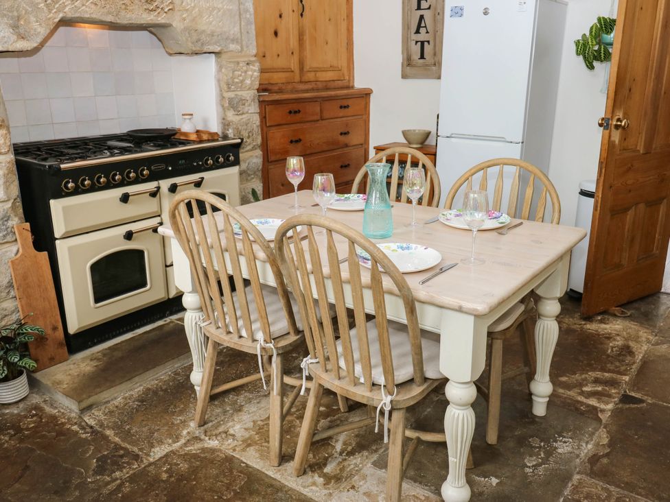 A kitchen with a dining table and chairs at 10 Park Road
