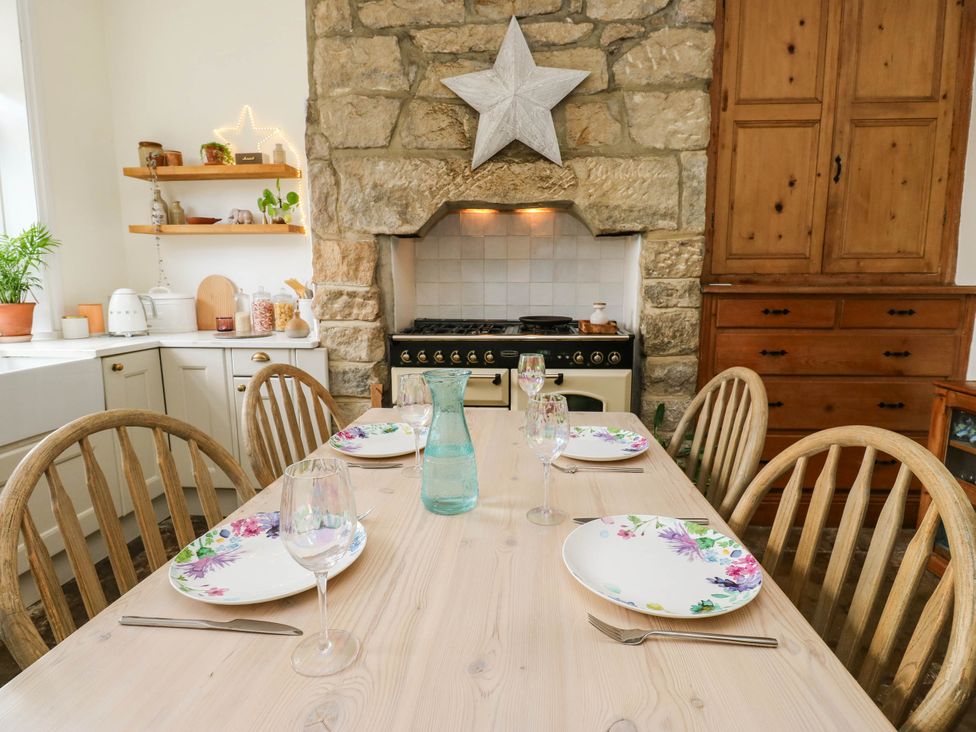 A dining room with a wooden table set for dinner at 10 Park Road