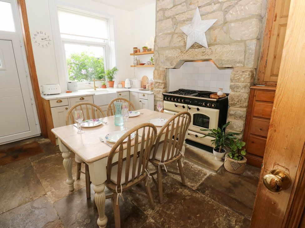 A kitchen with a dining table and an oven at 10 Park Road 