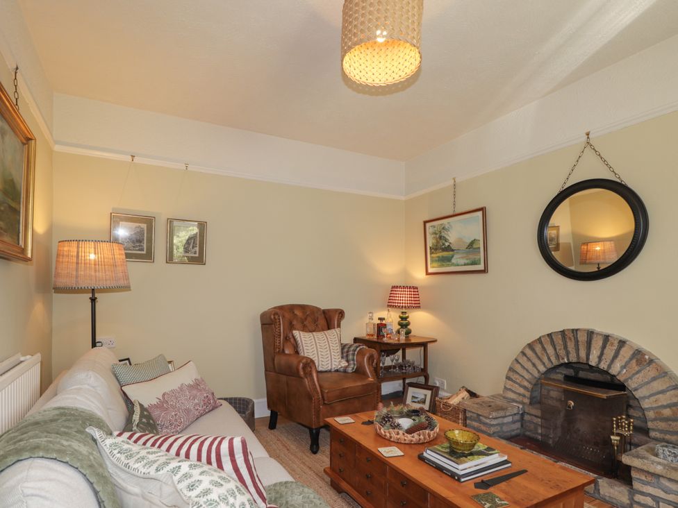 A living room with a sofa and a chair at Gairnshiel School House near Ballater
