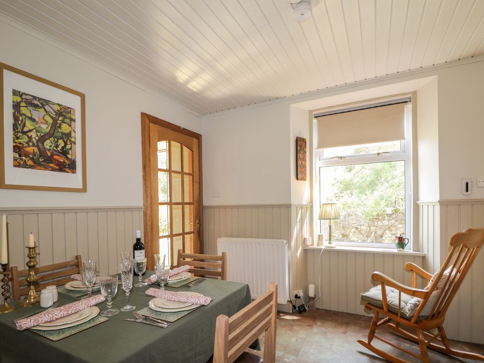A dining room with a table set for dinner at Gairnshiel School House near Ballater