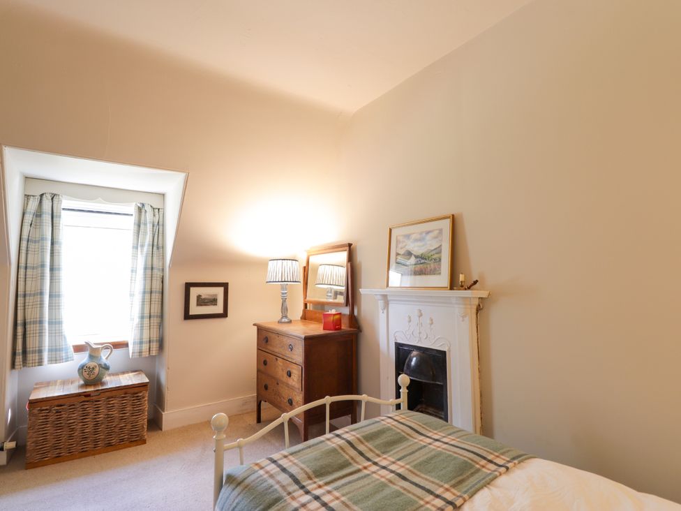 A bedroom with a bed and chest of drawers at Gairnshiel School House near Ballater