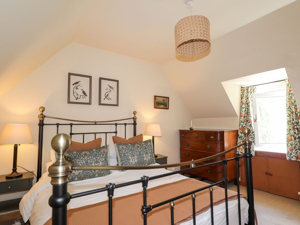 A bedroom with a bed and furniture at Gairnshiel School House near Ballater