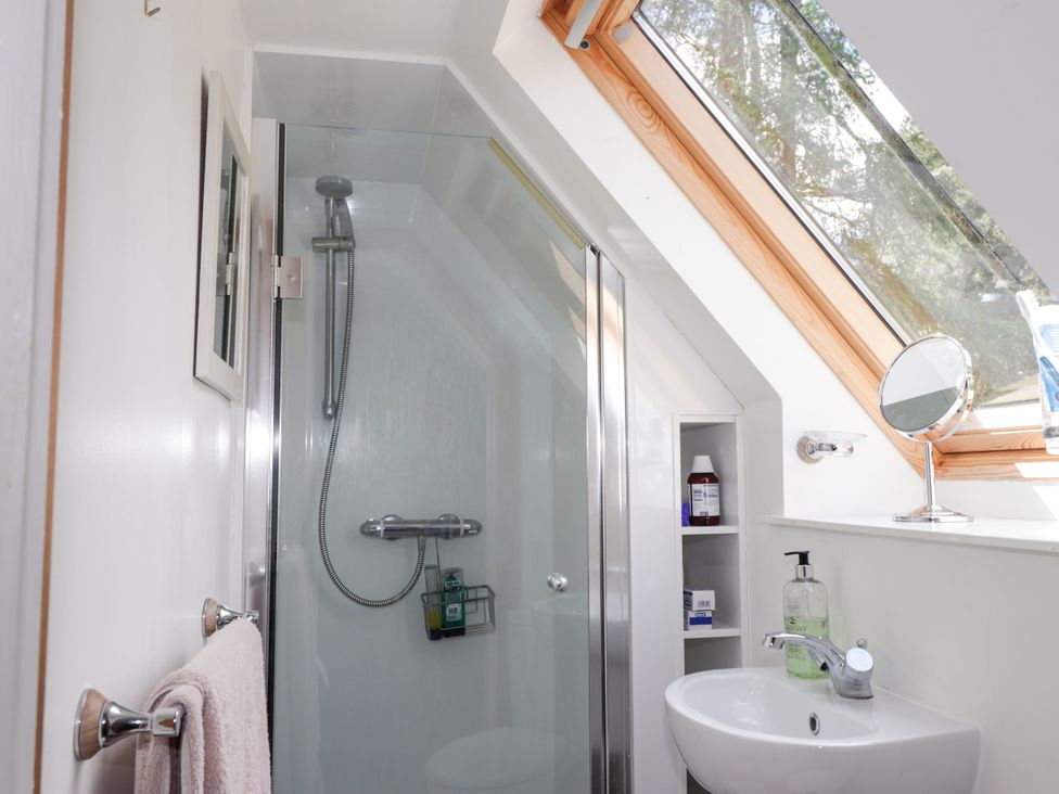 A bathroom with a shower and sink at Gairnshiel School House near Ballater