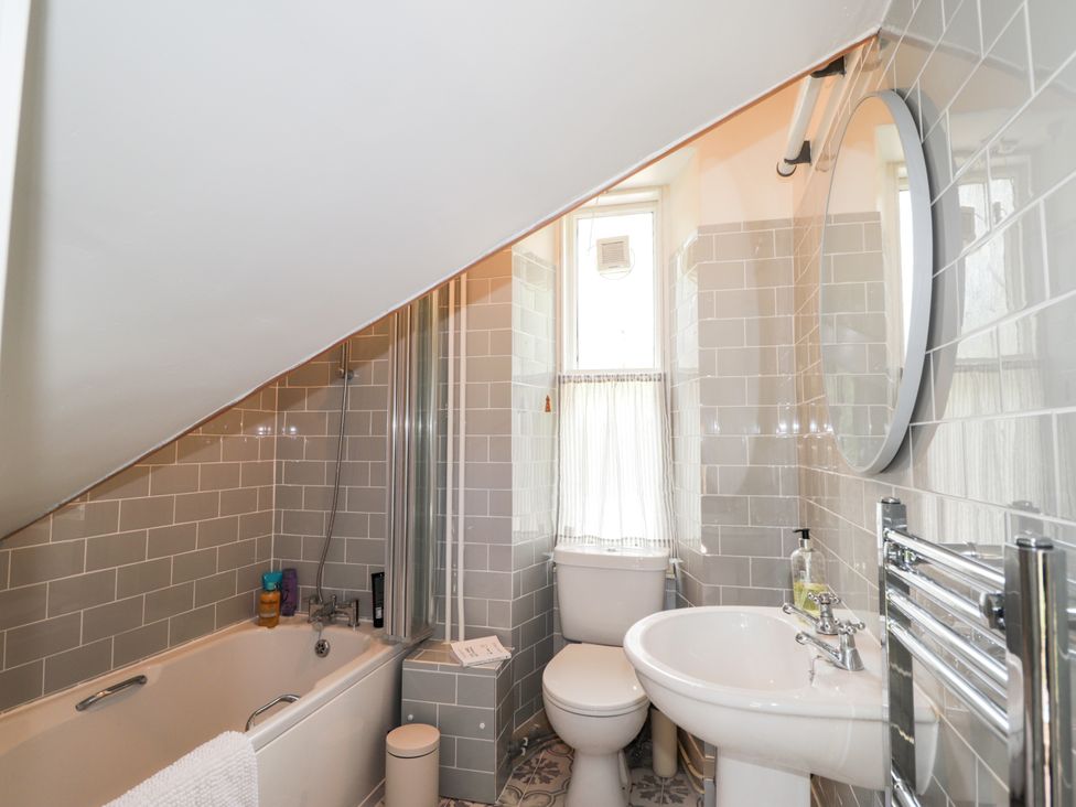 A bathroom with a bathtub, shower, sink, and toilet at Gairnshiel School House near Ballater
