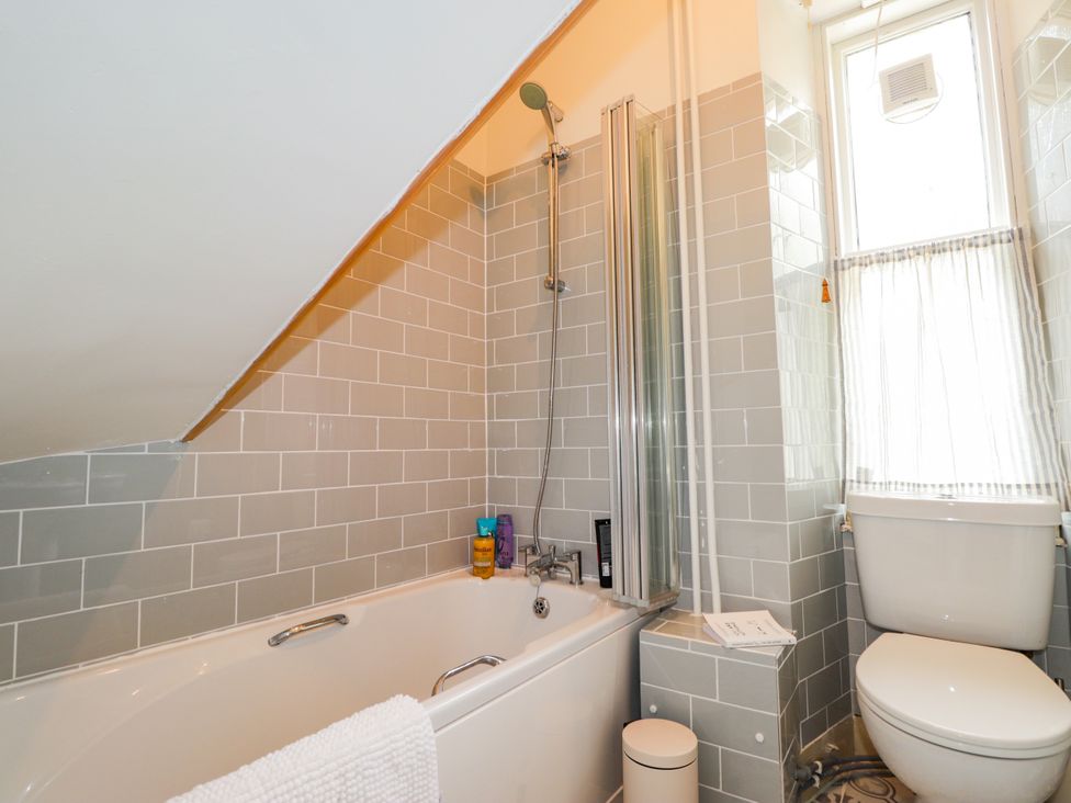 A bathroom with a bathtub and shower at Gairnshiel School House near Ballater