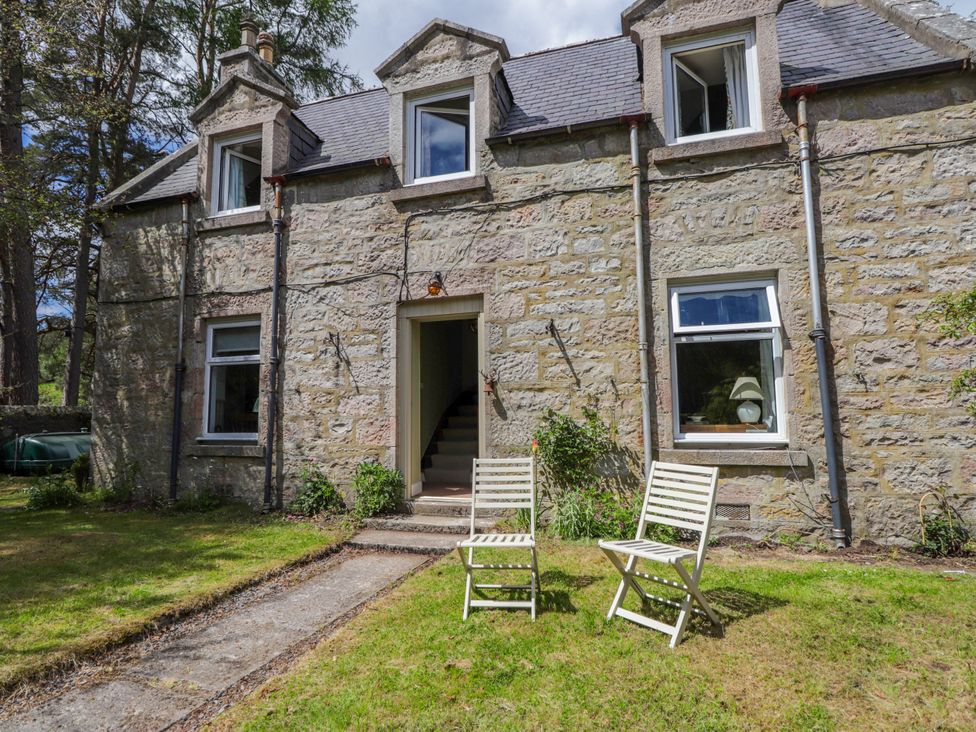 A house with two chairs and a pathway at Gairnshiel School House near Ballater