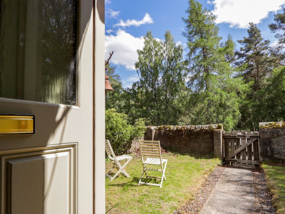 A garden with chairs and a pathway at Gairnshiel School House near Ballater