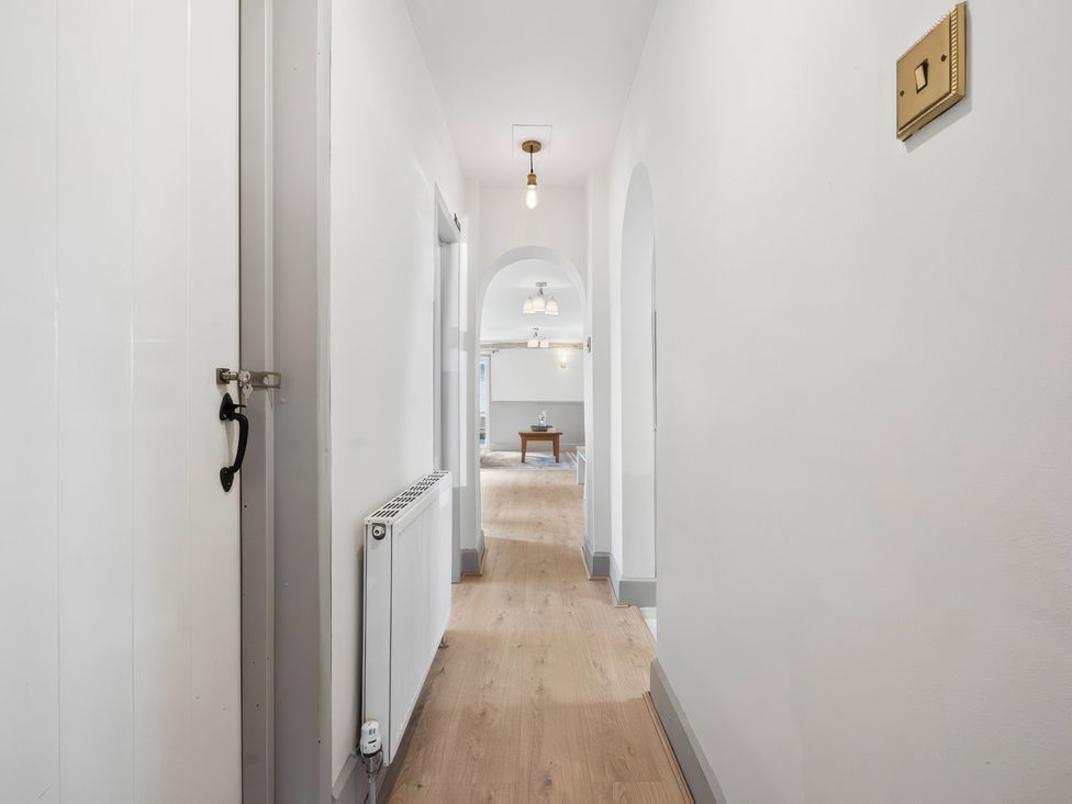 A hallway with a radiator and light fixture at 5 Acres Cottage Rickmansworth