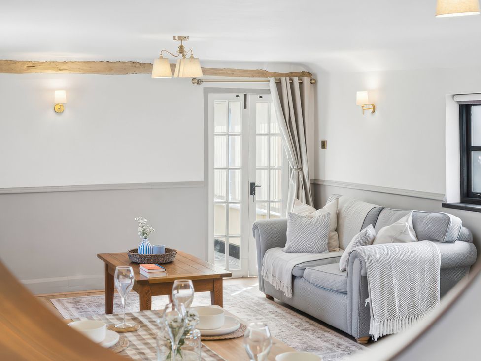 A living room with a sofa and coffee table at 5 Acres Cottage in Rickmansworth