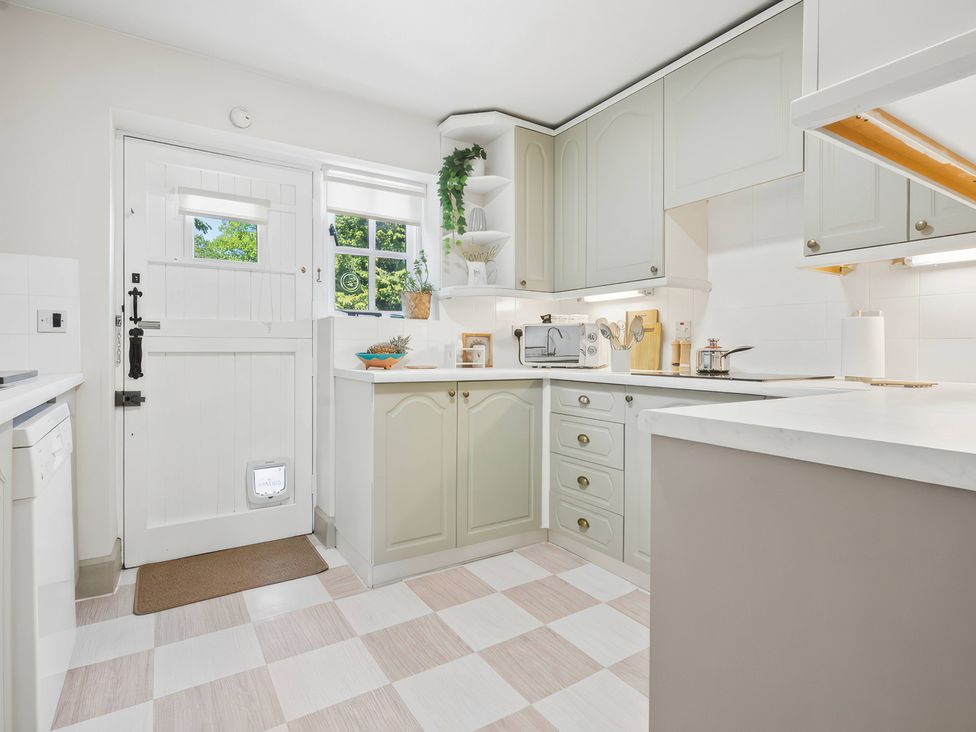 A kitchen with cabinets and appliances at 5 Acres Cottage in Rickmansworth