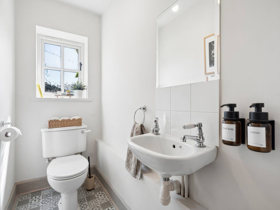 A bathroom with a toilet and sink at 5 Acres Cottage in Rickmansworth