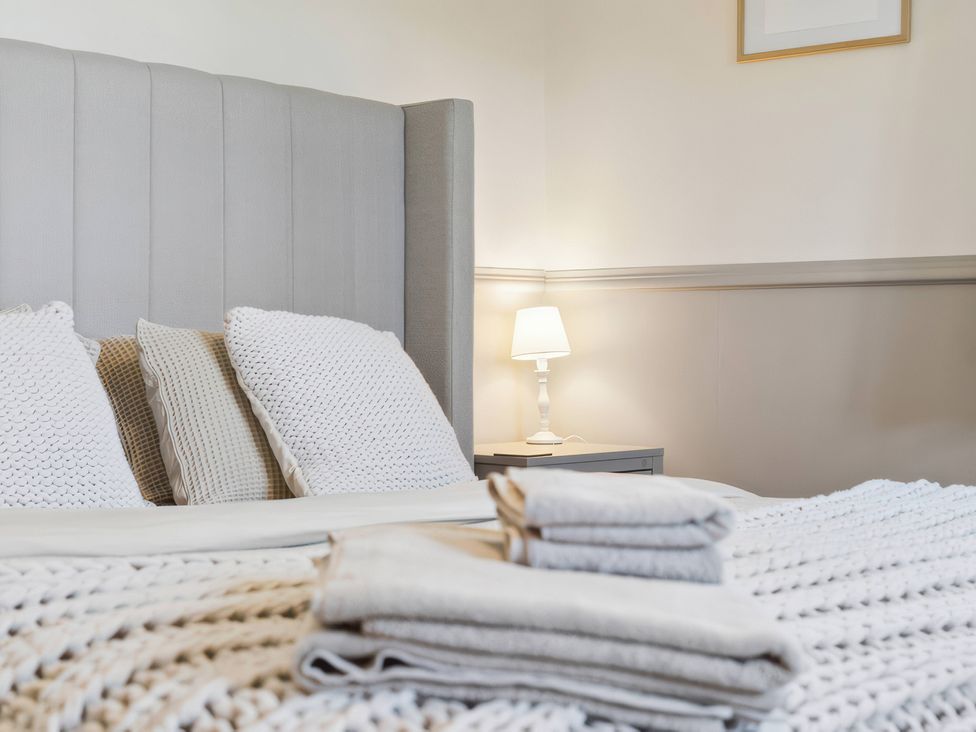 A bedroom with a bed and lamp at 5 Acres Cottage in Rickmansworth