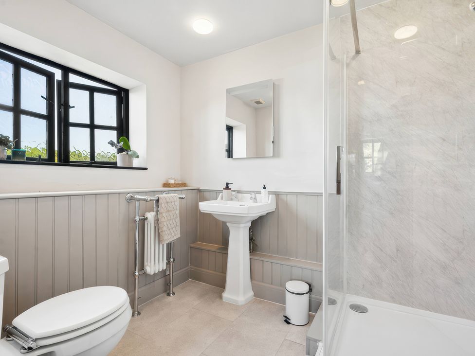 A bathroom with a sink and shower at 5 Acres Cottage in Rickmansworth