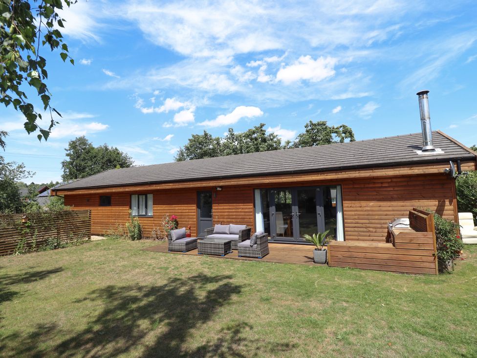 A house with outdoor seating and a garden at 80 Pentney Lakes in Pentney near King's Lynn