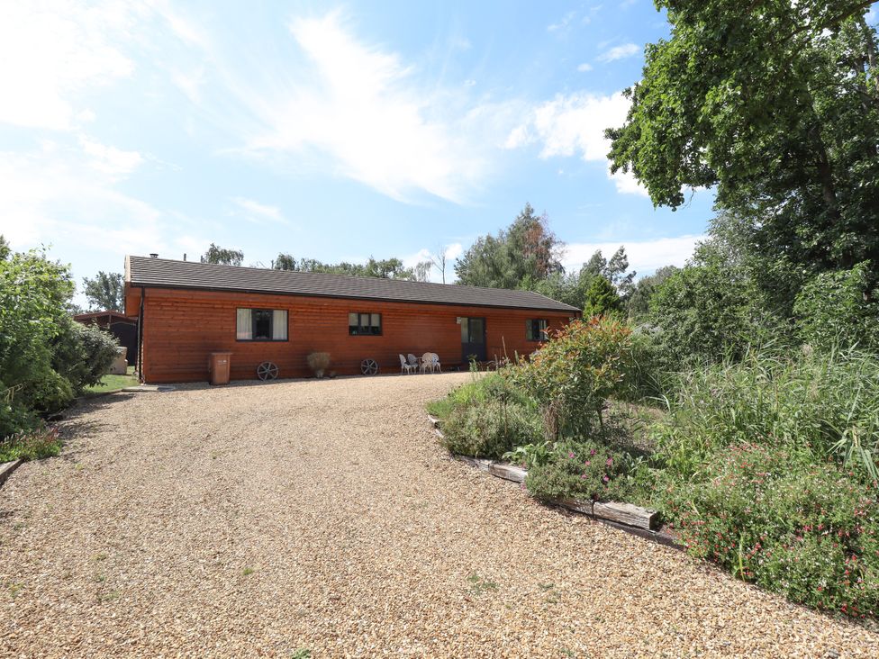 A house with a gravel driveway and garden at 80 Pentney Lakes in Pentney near King's Lynn