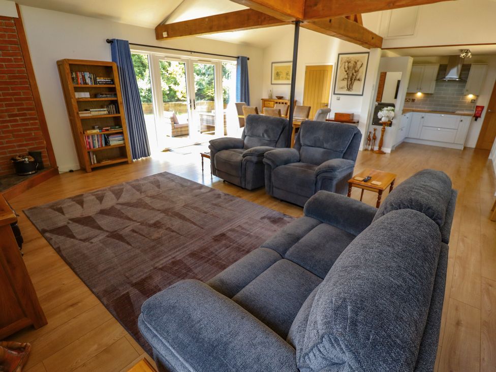 A living room with couches and a bookcase at 80 Pentney Lakes in Pentney near King's Lynn