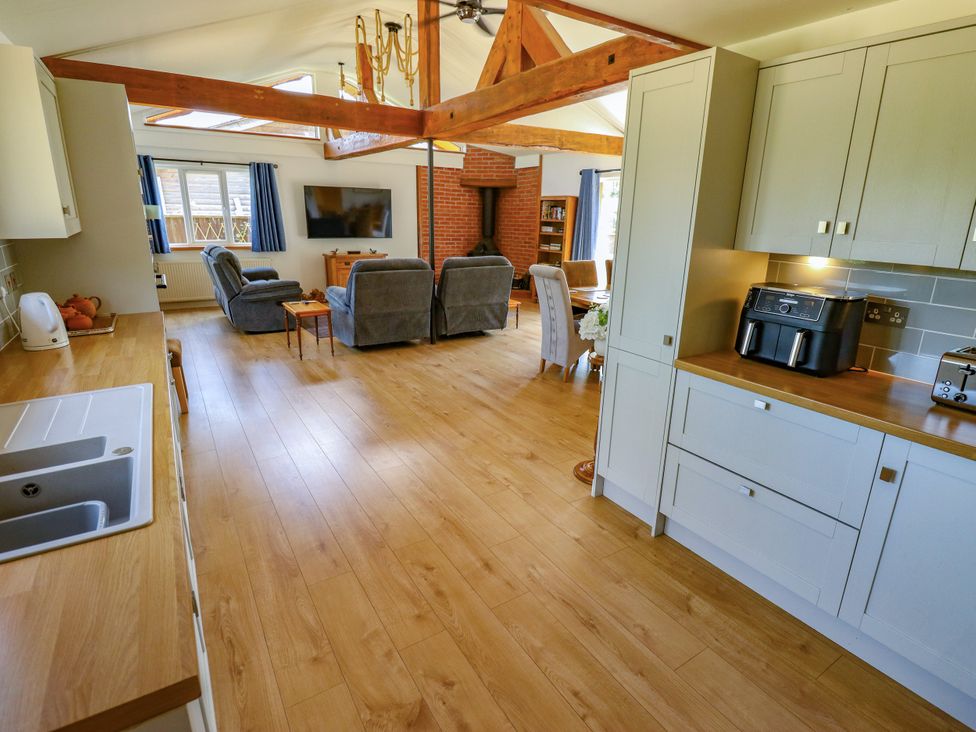 A kitchen with a sink and an open living space at 80 Pentney Lakes Pentney near King's Lynn