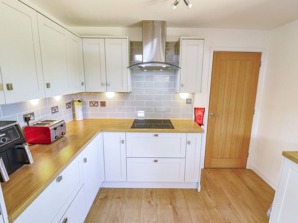 A kitchen with cabinets and appliances at 80 Pentney Lakes in Pentney near King's Lynn