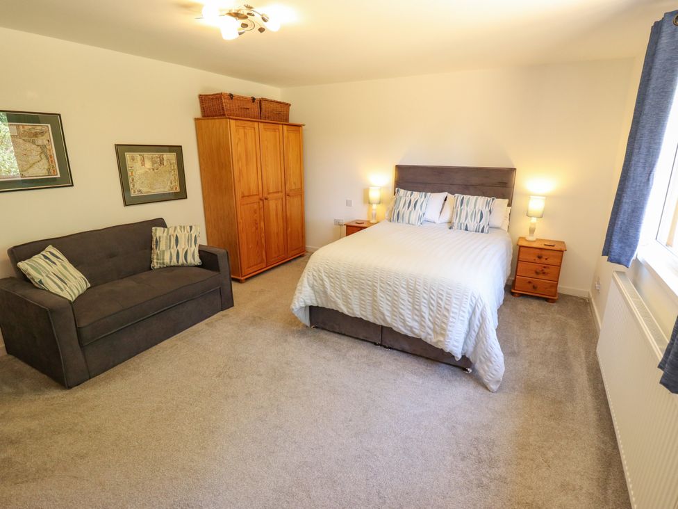 A bedroom with a bed and a sofa at 80 Pentney Lakes in Pentney near King's Lynn