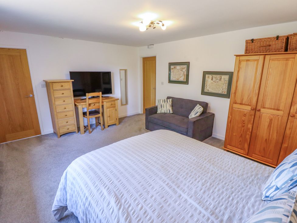 A bedroom with a bed, sofa and television at 80 Pentney Lakes in Pentney near King's Lynn