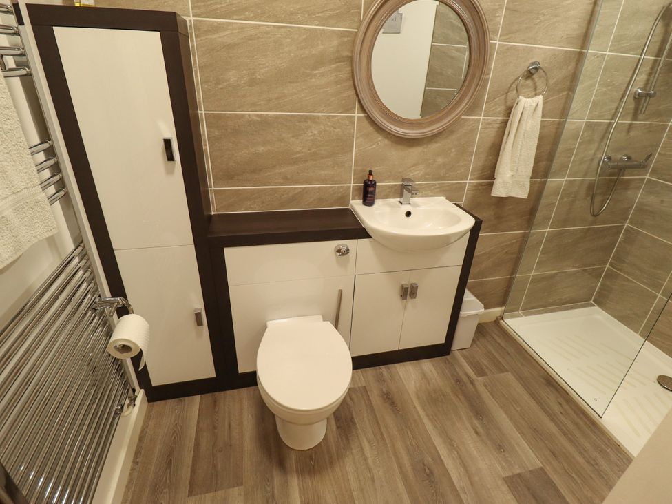 A bathroom with a shower, sink, and toilet at 80 Pentney Lakes, Pentney near King's Lynn