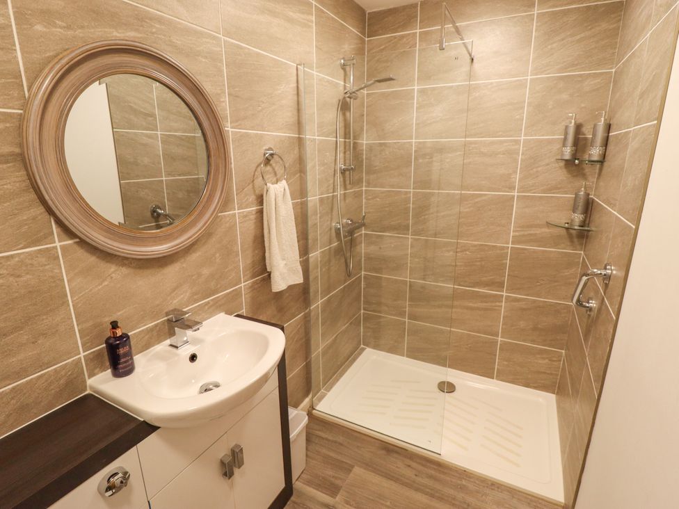 A bathroom with a shower and wash basin at 80 Pentney Lakes in Pentney near King's Lynn