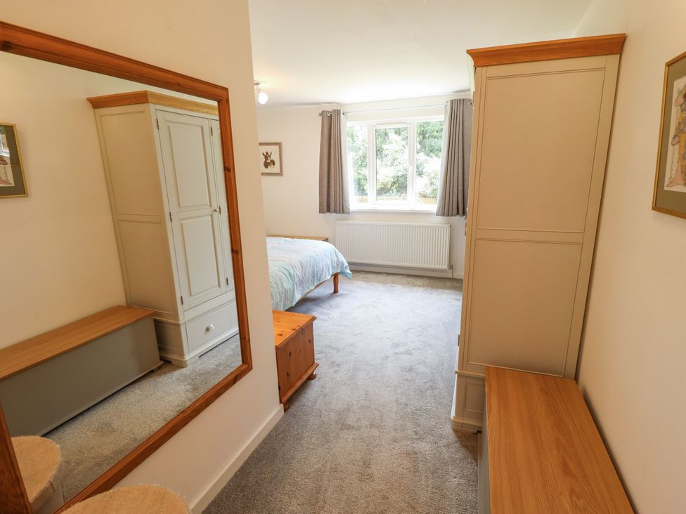 A bedroom with a bed and wardrobe at 80 Pentney Lakes near King's Lynn