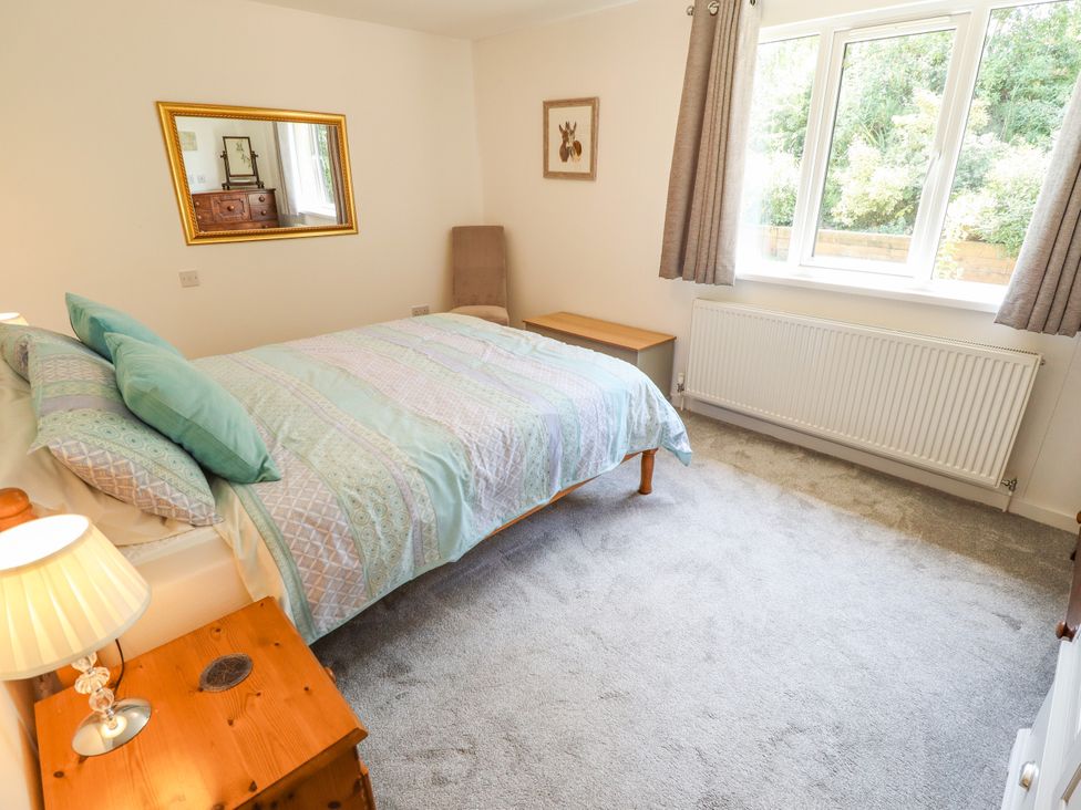 A bedroom with a bed and a nightstand at 80 Pentney Lakes in Pentney near King's Lynn