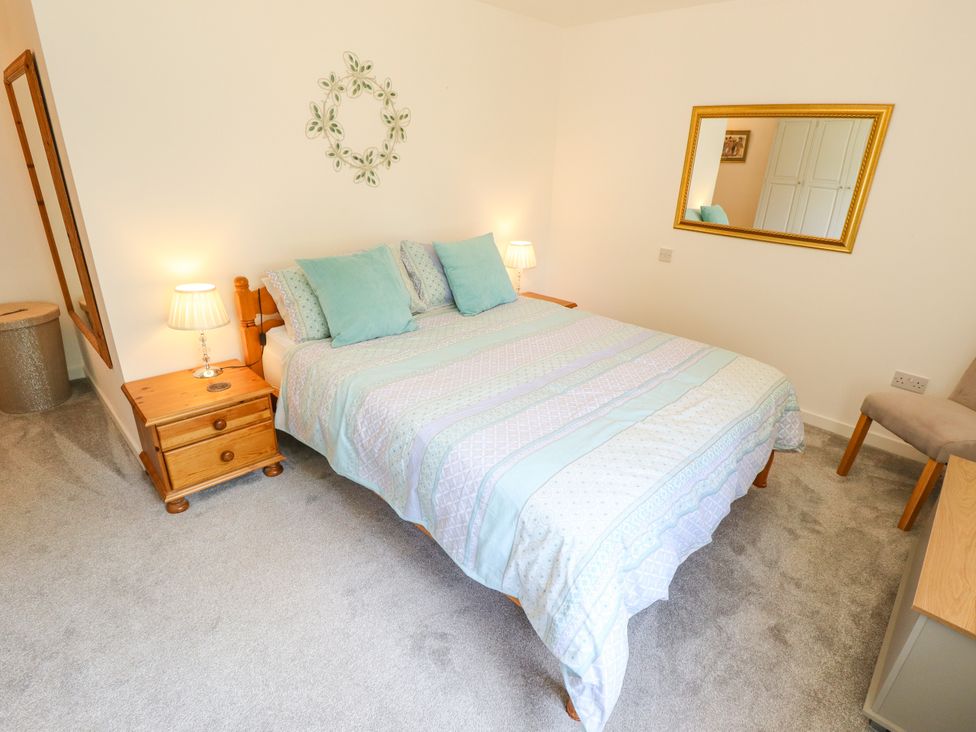 A bedroom with a bed and nightstand at 80 Pentney Lakes Pentney near King's Lynn